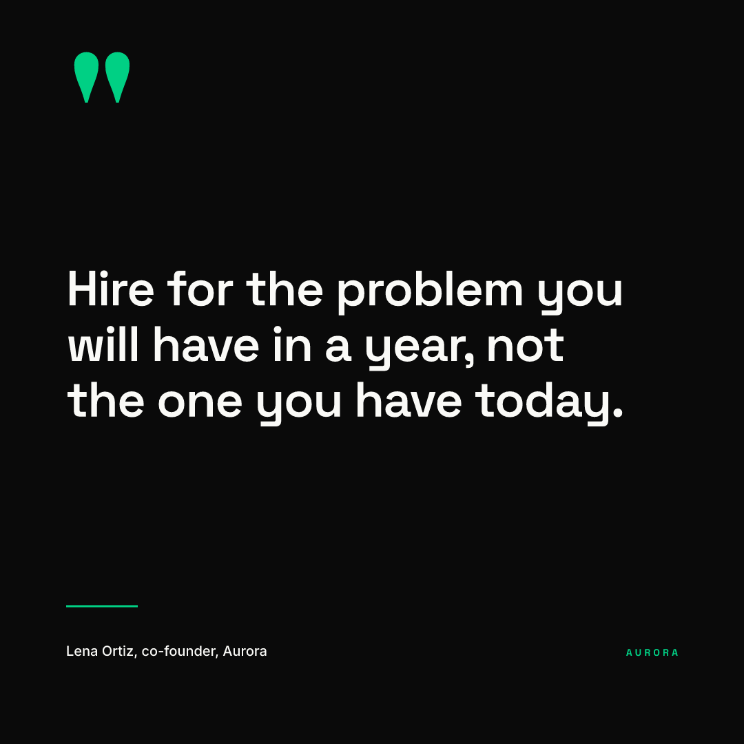Square quote post rendered from our AURORA demo brand: a black background, a green quotation mark top left, the white quote Hire for the problem you will have in a year, not the one you have today, and the attribution Lena Ortiz, co-founder, Aurora with a small green AURORA wordmark at bottom right